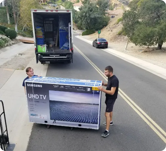 movers carrying TV